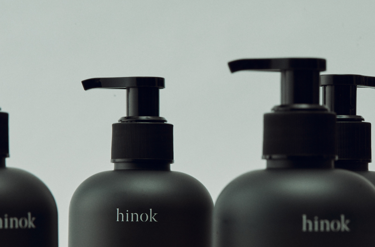 Matte black hinok bottles with pump dispensers, minimalist design for mindful self-care rituals
