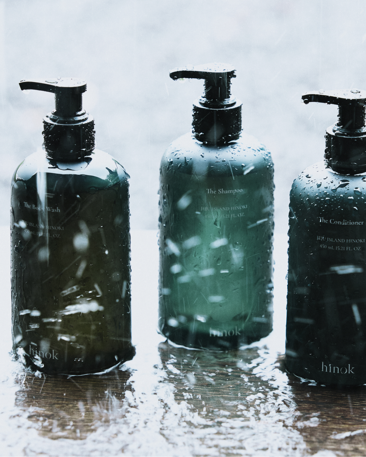 The Shower Set with Shampoo, Conditioner, Body Wash, and green linen pouch